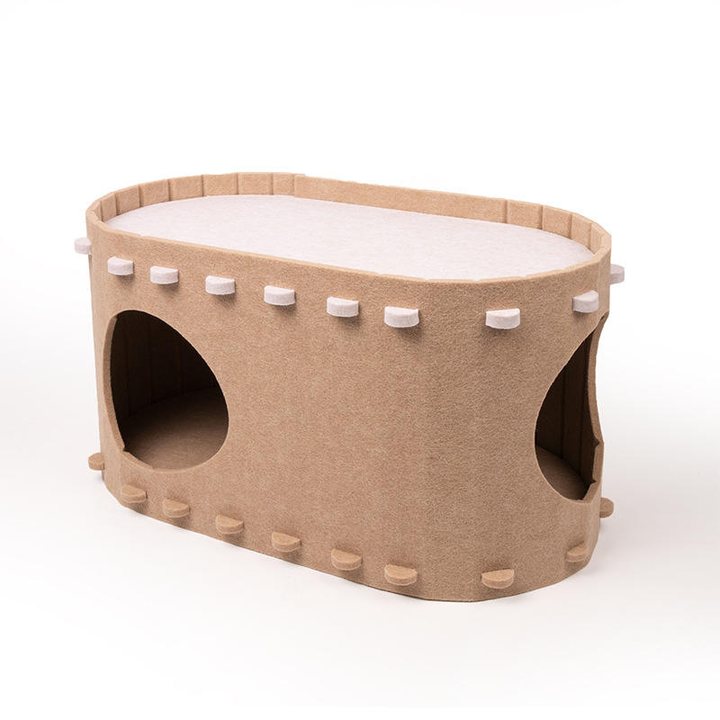Tan felt oval cat house with two round side entrances and a stitched cream top panel.