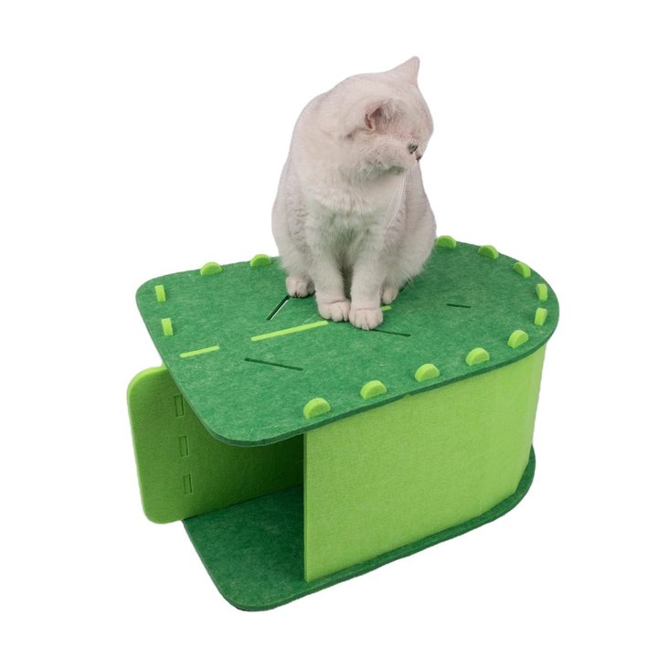 Green felt oval cat house with two round side entrances and a laced top deck, shown with a cat sitting on top.