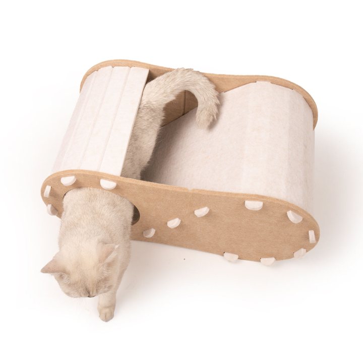 Cream felt cat tunnel bed with a laced trim, shown with a cat passing through the tunnel opening.
