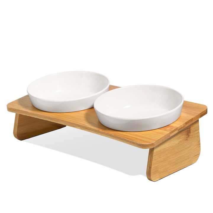 Two round white bowls set into a light bamboo stand.