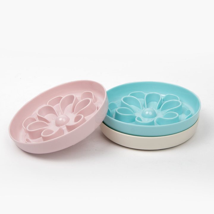 Flower-shaped pet slow feeder bowls in pink and teal