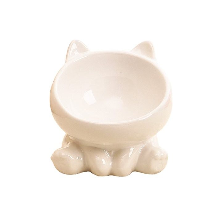 White ceramic pet bowl moulded in the shape of a cat's face, with paw-shaped feet forming the base.