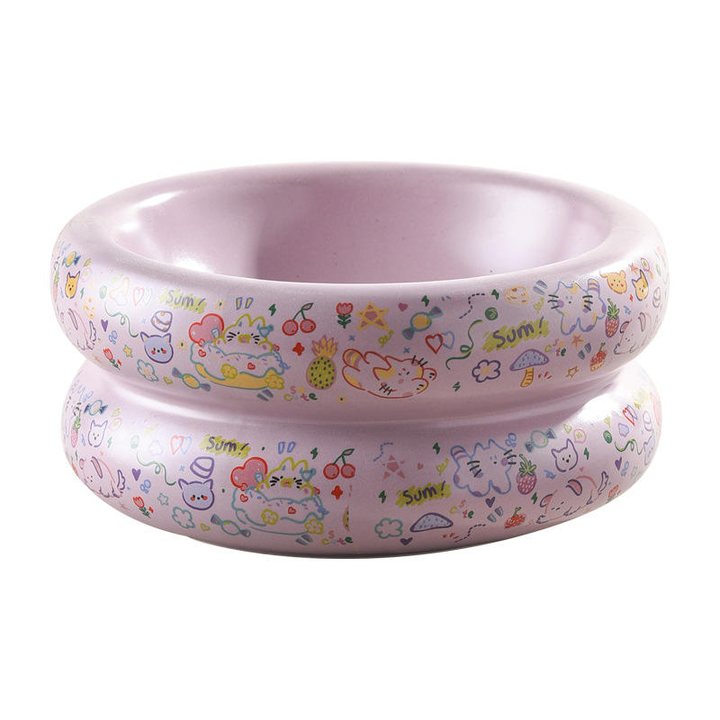 Double-ring lilac ceramic cat bowl with a colourful cartoon doodle print around the outside.