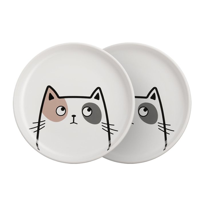 Two flat white ceramic dishes, each printed with a simple cartoon cat-face design.