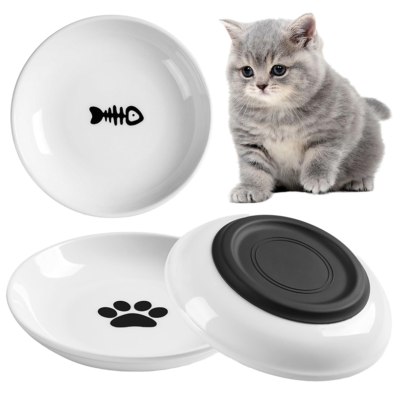 White shallow dishes with fishbone and paw decoration, including an underside view with a dark circular base.