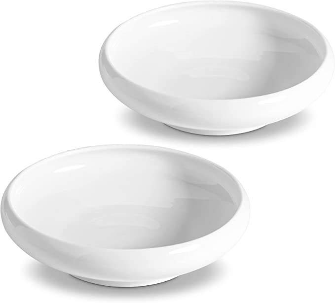 Two shallow wide-oval white ceramic pet dishes.