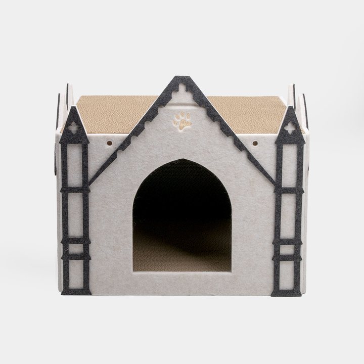 White felt gothic-castle-shaped cat house with dark grey trim, twin corner spires, and an arched entrance.