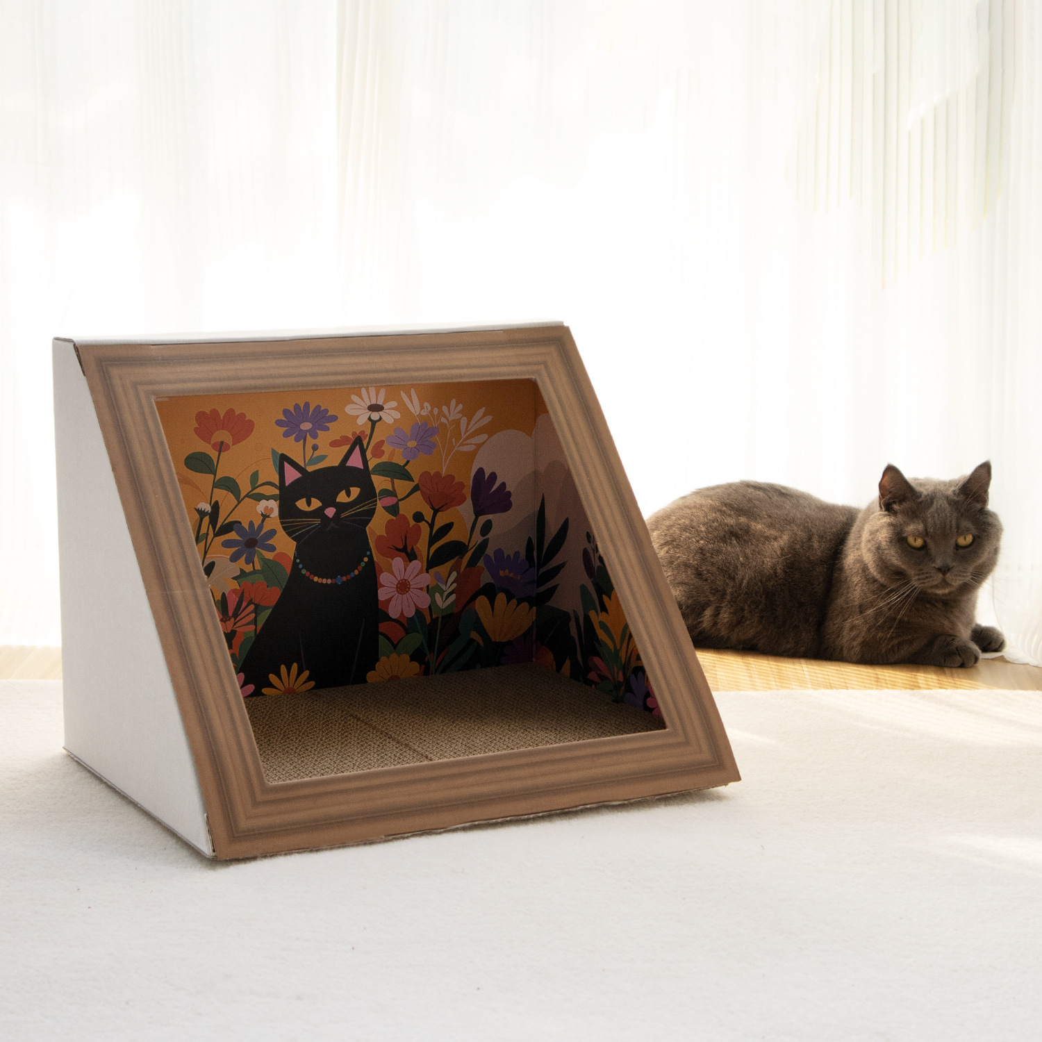 Wedge-shaped corner cat house with white sides, a brown frame-like front and a corrugated floor; a cat is beside it.