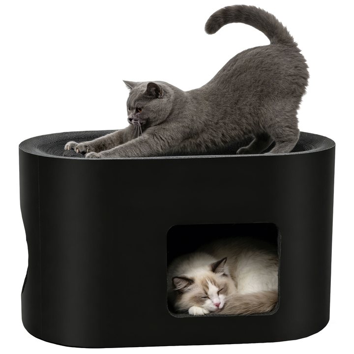 Black corrugated cardboard cat house with a scratch-pad top, one cat stretching on top and another resting inside.