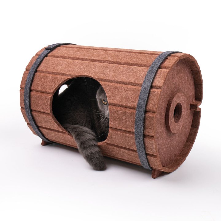 Barrel-shaped felt cat house with hoop bands and a decorative bunghole detail, cat peeking from the entrance.