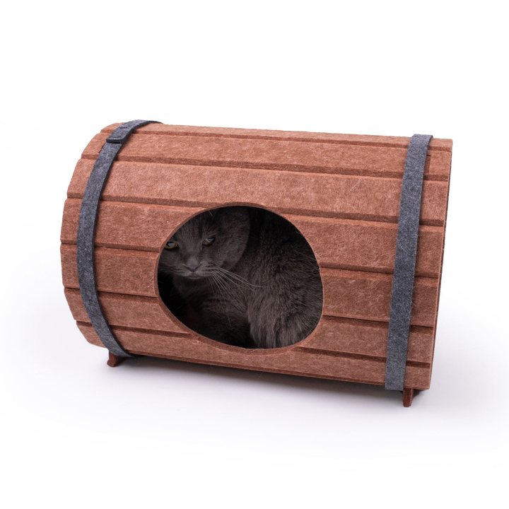 Barrel-shaped felt cat house with hoop bands, a cat visible resting inside the entrance.