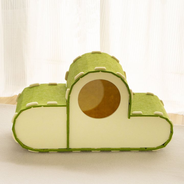 Cloud-shaped green felt cat house with a round entrance opening