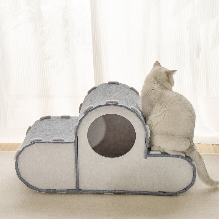 Cloud-shaped grey felt cat house with a round entrance opening