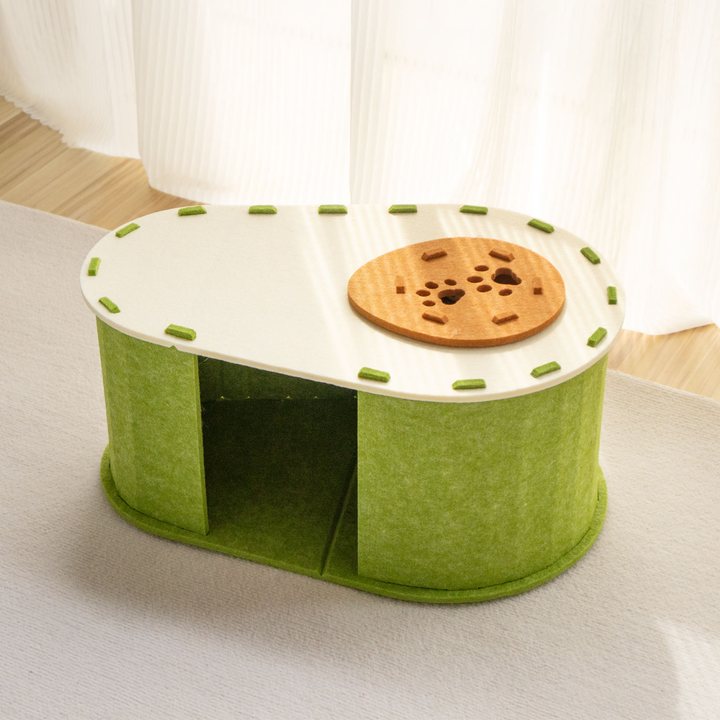 Peanut-shaped green felt cat house with a round paw-print patterned lid