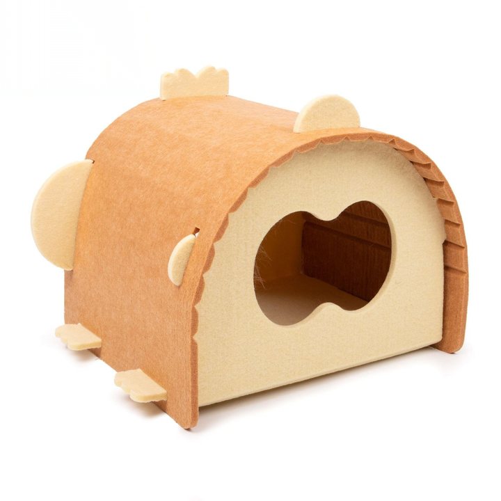 Arched pet house made of tan and light-beige felt-covered board, with a scalloped roofline, two round ear-like domes on the sides, small crown-shaped tabs along the peak, and a large heart-shaped entrance opening revealing a wood-toned interior.