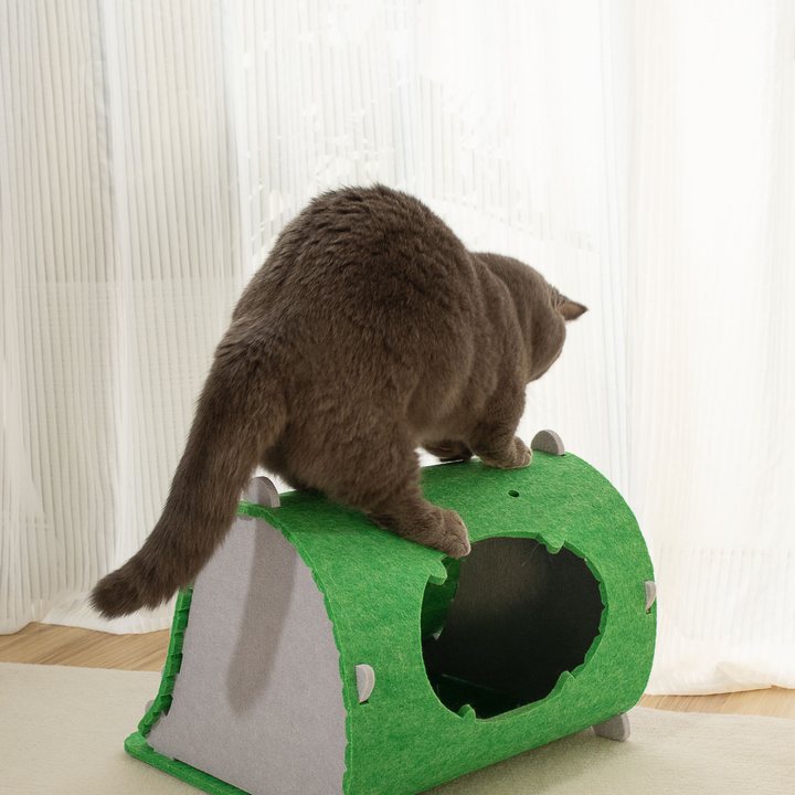 Arched felt cat house in green with a gray triangular side panel and small spike trim along the roofline, oval entrance