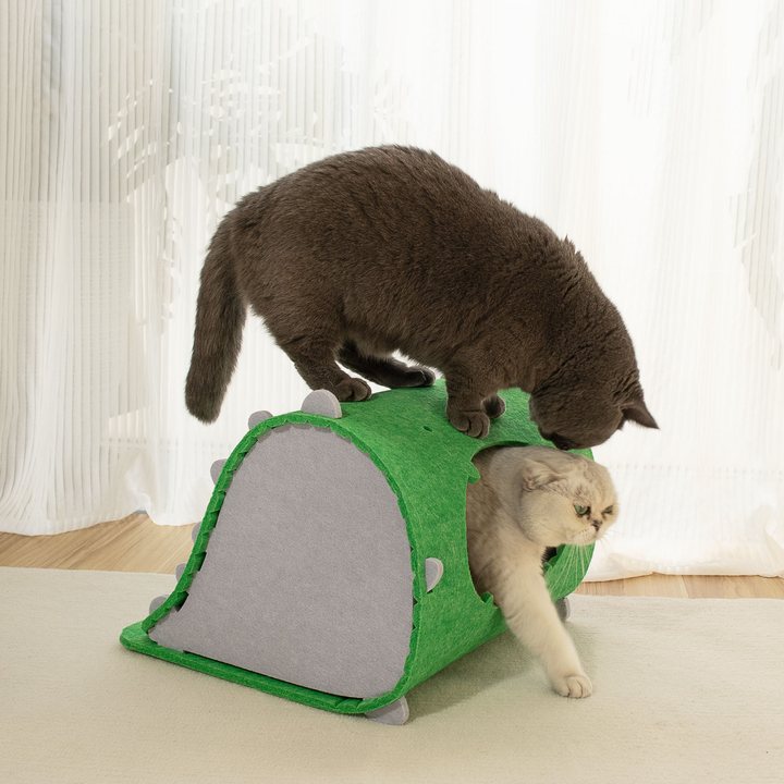 Arched felt cat house in green with a gray triangular side panel and small spike trim, two cats shown using the tunnel opening
