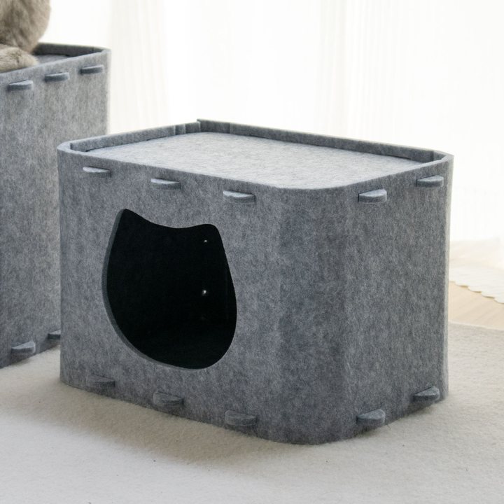 Gray felt box cat house with a cat-head-shaped doorway cut into the front panel