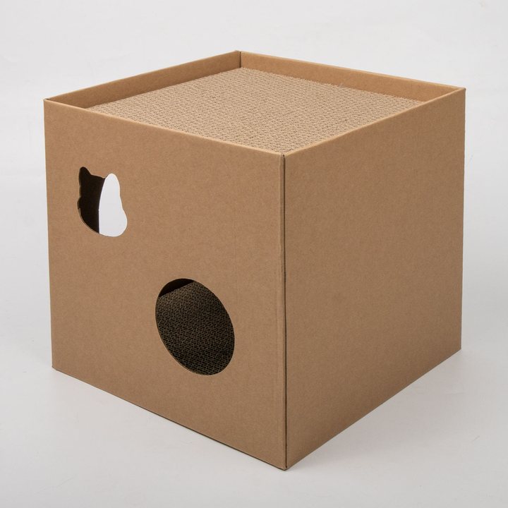 Kraft-brown corrugated cardboard cube cat house with a cat-face cutout window, round entrance hole, and a corrugated scratch-pad top.
