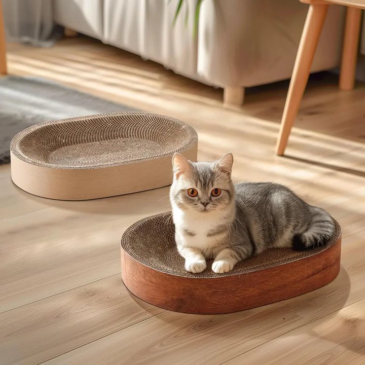 Two oval cat scratcher beds, one plain cardboard and one wood-grain finish, shown with a cat sitting in one