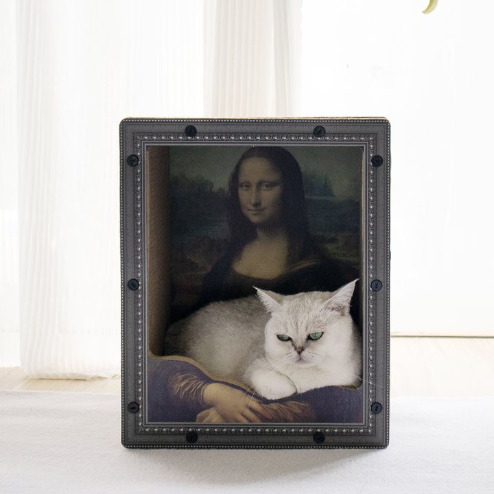 Black ornate picture-frame-shaped cat scratcher bed with a classical painting print, cat resting inside