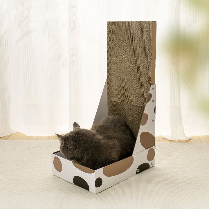 Wedge-shaped cardboard cat scratcher lounge with a printed spot pattern on the base and a tall corrugated scratch panel.