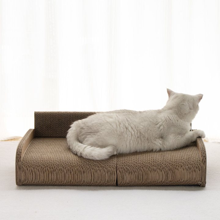 Plain corrugated cardboard sofa-style cat scratcher with a low backrest.