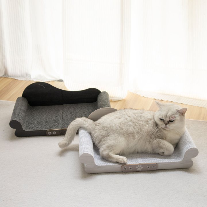 Scroll-arm corrugated cardboard cat scratcher lounge in light grey, shown with a dark color variant behind it.