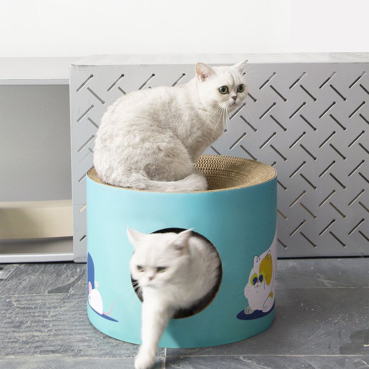 Cylindrical corrugated cardboard cat house and scratcher in teal with a round side entrance.