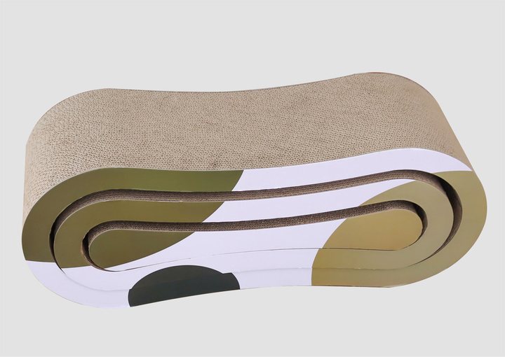 A curved, S-shaped corrugated cardboard cat scratcher lounge, tan/beige textured top surface with an olive-green, white, and black abstract pattern on the sides, photographed on a plain light grey background.