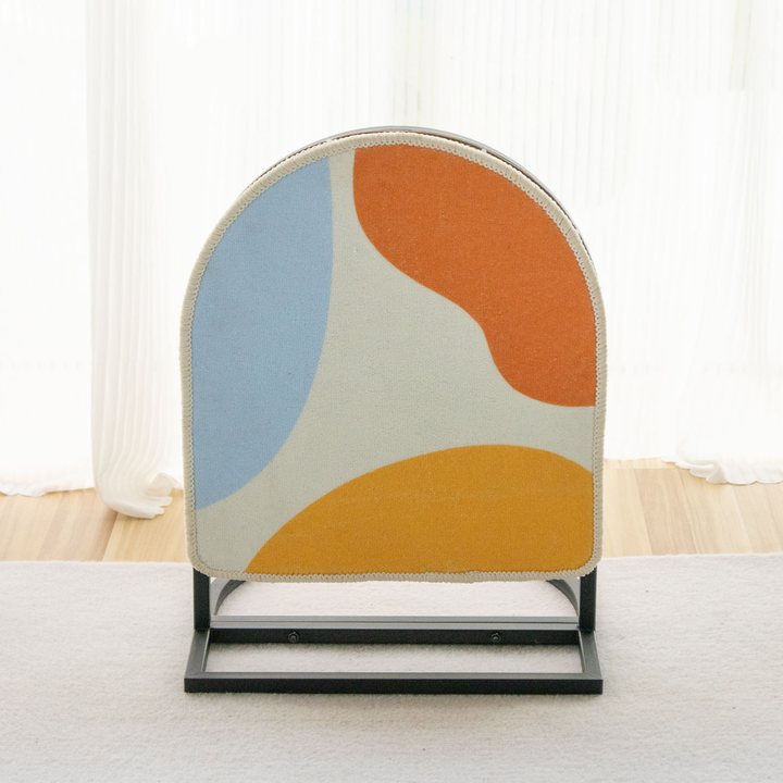 Arched cat scratch board with an abstract color-block print, mounted on a black metal floor stand