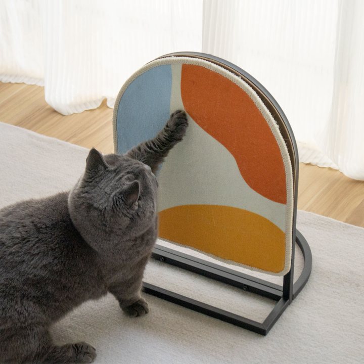 Arched cat scratch board with an abstract color-block print on a metal floor stand
