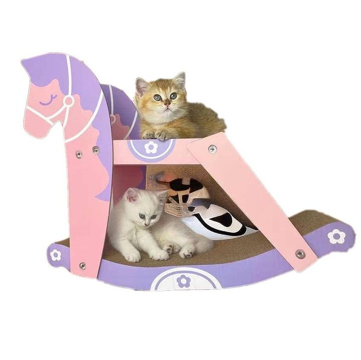 Rocking-horse-shaped cardboard cat scratcher in pink and lavender, shown with kittens playing on it.