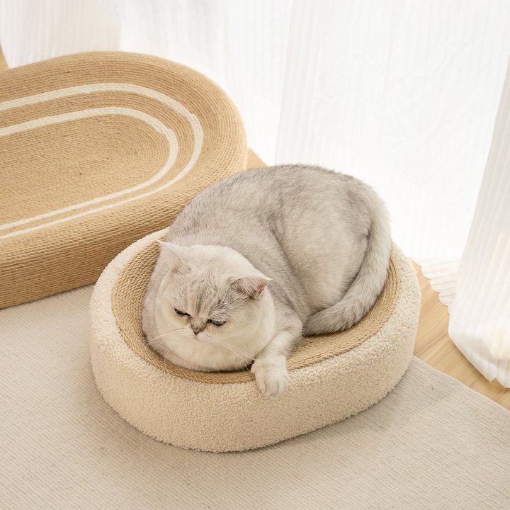 Oval woven sisal-style cat scratcher bed with a plush cream fabric rim