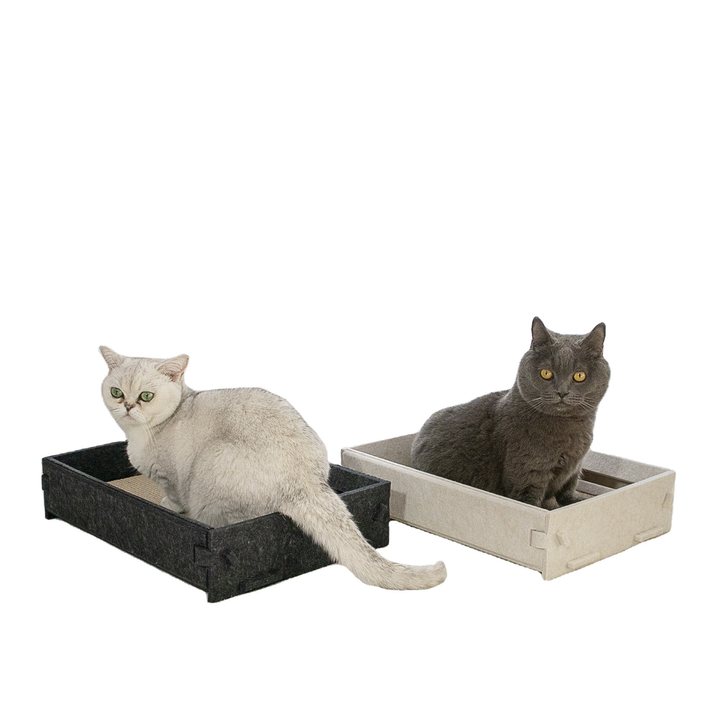 Two rectangular felt-sided scratcher trays, one charcoal grey and one cream, each fitted with a corrugated cardboard scratch pad