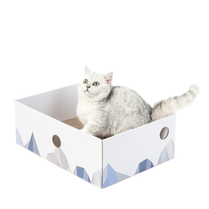 White cardboard cat scratcher box printed with a mountain-peak design and round side cutouts