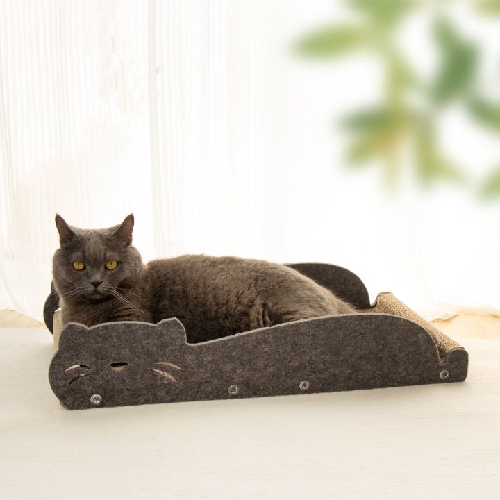 Charcoal grey felt cat scratcher sofa lounge shaped like a cat silhouette, with a raised backrest and a corrugated cardboard scratch pad seat