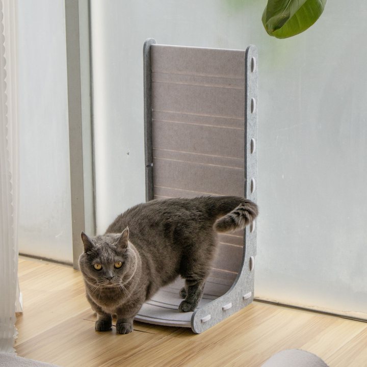 Light grey felt L-shaped cat scratcher ramp with a tall vertical back panel and a curved corrugated cardboard scratch strip