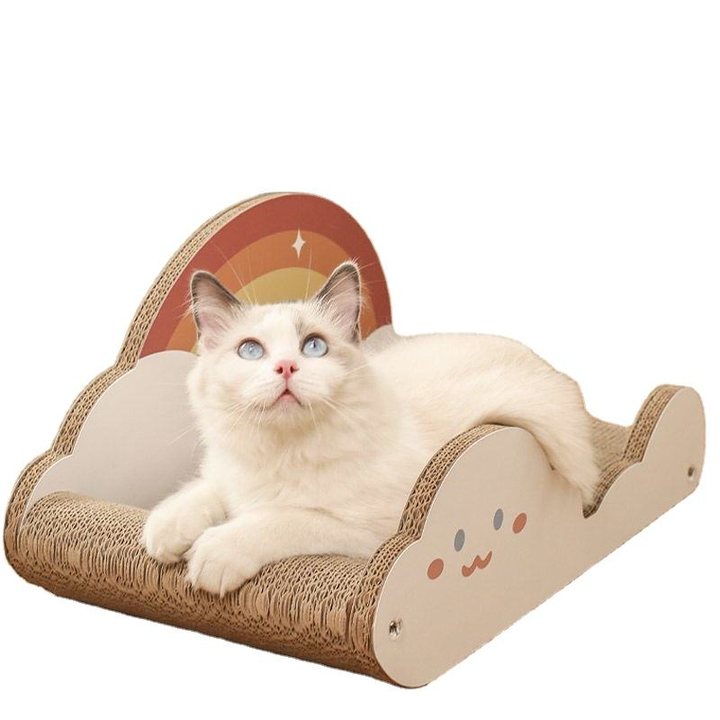 Cloud-shaped corrugated cardboard cat scratcher lounge with a printed rainbow backrest and a smiling cloud face on the side.