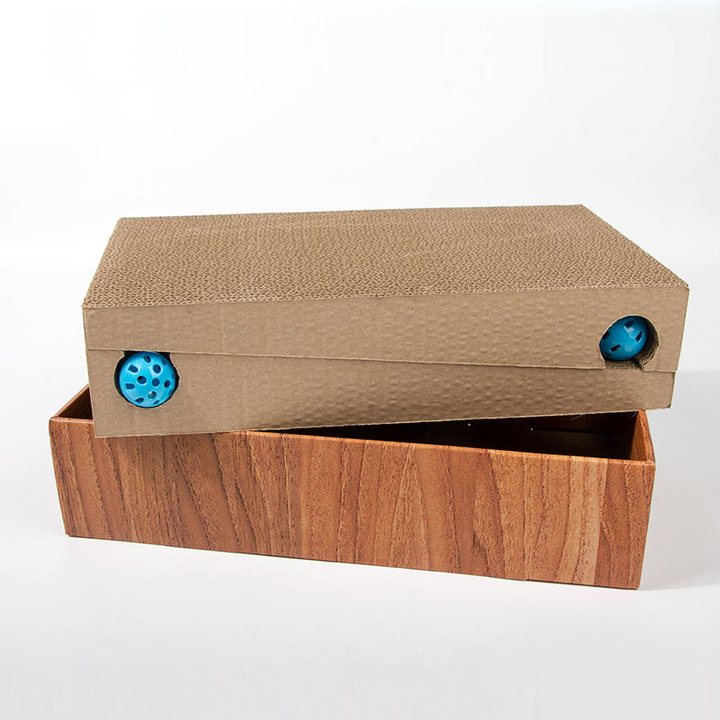 Rectangular cat scratch pad box with a wood-grain printed base and a built-in ball track holding two blue balls.