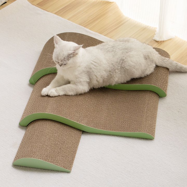 Wave-shaped corrugated cardboard cat scratch pad with a green edge trim, arranged in tiers.