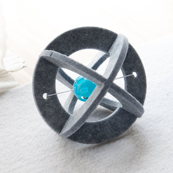 Grey felt banded sphere cat toy with a small rattle ball nested at its center.